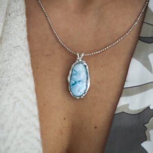 A close up of a person wearing a necklace