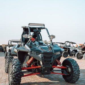A four - wheeler is parked in a parking lot