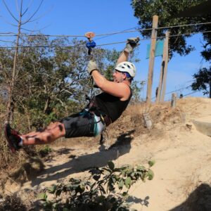 a man is zipping through the air on a rope