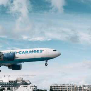 a large airplane flying over a city