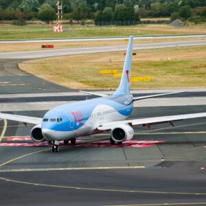 parked white and blue airplane