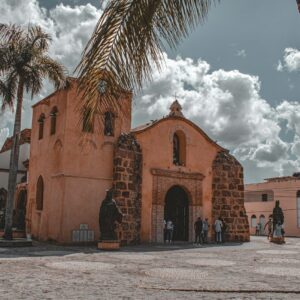a church with a palm tree in front of it