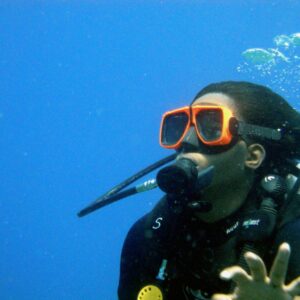 a person wearing a scuba suit and goggles in the water