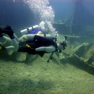 a man in a scuba suit is swimming in the water
